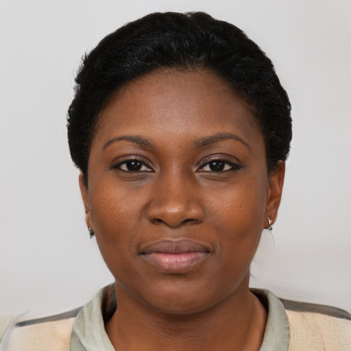 Joyful black young-adult female with short  black hair and brown eyes