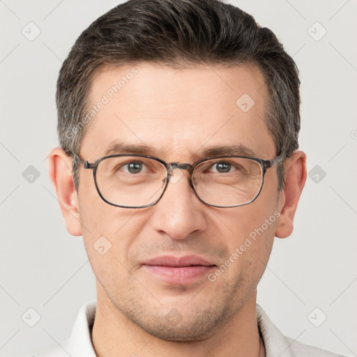 Joyful white adult male with short  brown hair and grey eyes