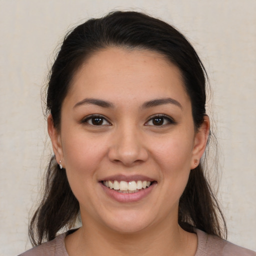 Joyful white young-adult female with medium  brown hair and brown eyes