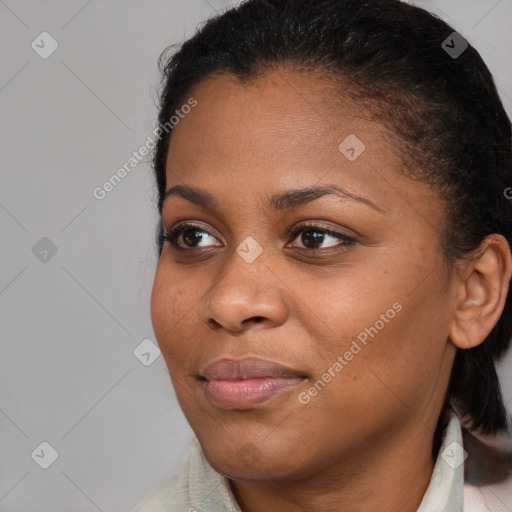 Joyful black young-adult female with short  brown hair and brown eyes