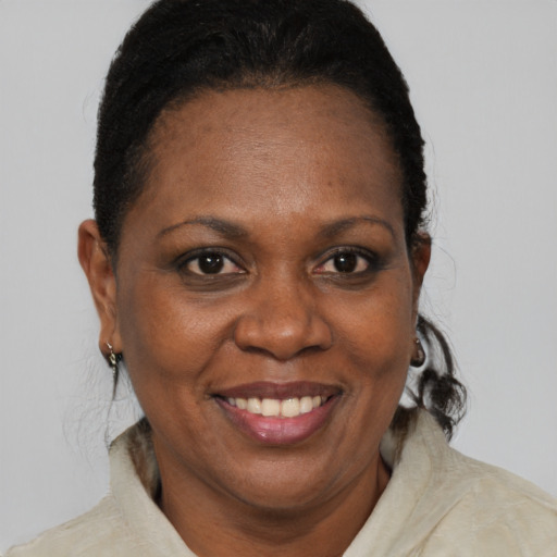 Joyful black adult female with short  brown hair and brown eyes