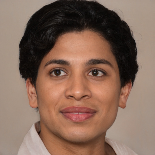 Joyful latino young-adult male with short  brown hair and brown eyes