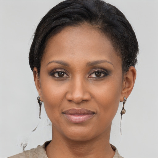 Joyful black young-adult female with short  brown hair and brown eyes