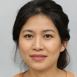 Joyful asian young-adult female with medium  brown hair and brown eyes