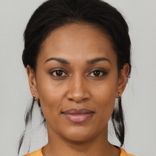 Joyful black young-adult female with medium  brown hair and brown eyes