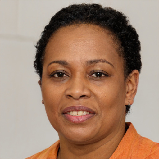 Joyful black adult female with short  brown hair and brown eyes