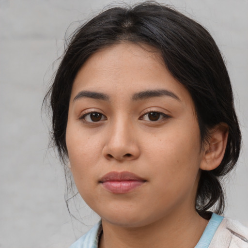 Joyful latino young-adult female with medium  brown hair and brown eyes