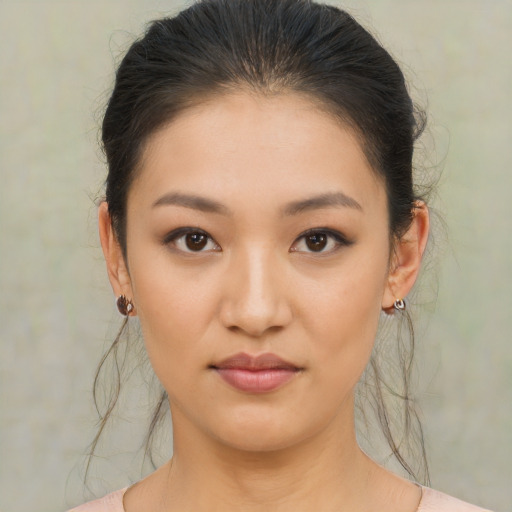Joyful asian young-adult female with medium  brown hair and brown eyes