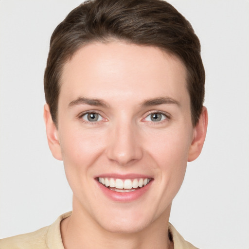 Joyful white young-adult female with short  brown hair and grey eyes