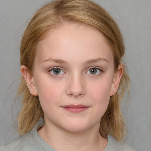 Joyful white child female with medium  brown hair and blue eyes