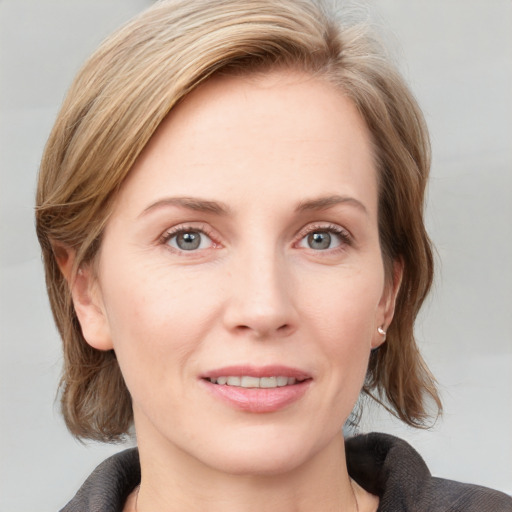 Joyful white young-adult female with medium  brown hair and blue eyes