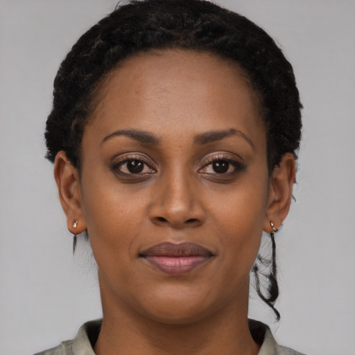 Joyful black young-adult female with short  brown hair and brown eyes
