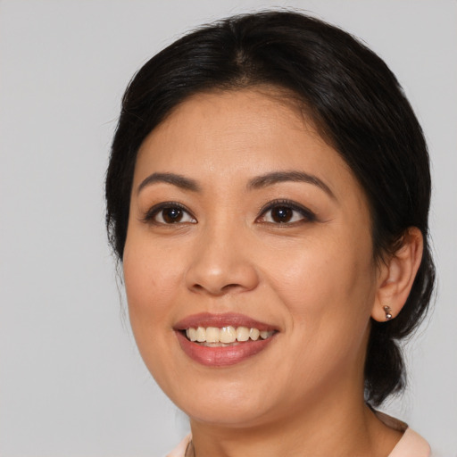 Joyful asian young-adult female with medium  black hair and brown eyes