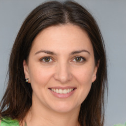 Joyful white young-adult female with medium  brown hair and brown eyes