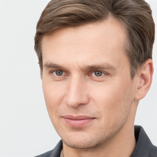 Joyful white adult male with short  brown hair and grey eyes