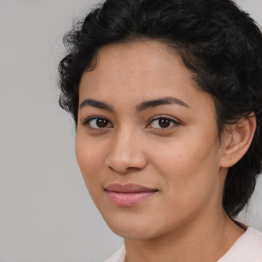 Joyful latino young-adult female with medium  brown hair and brown eyes