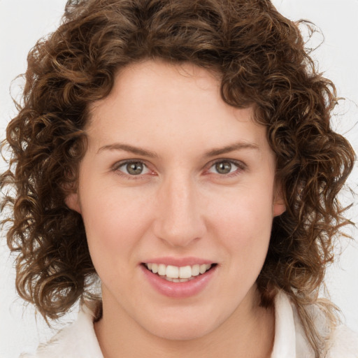 Joyful white young-adult female with medium  brown hair and green eyes