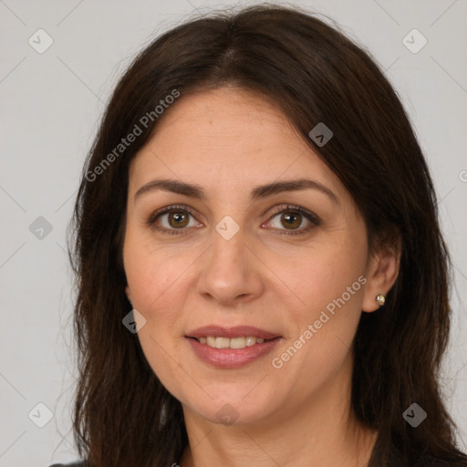 Joyful white adult female with long  brown hair and brown eyes