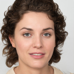 Joyful white young-adult female with medium  brown hair and green eyes