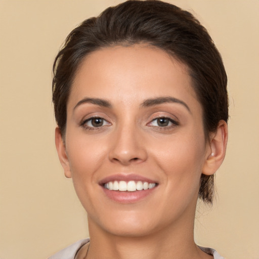 Joyful white young-adult female with long  brown hair and brown eyes