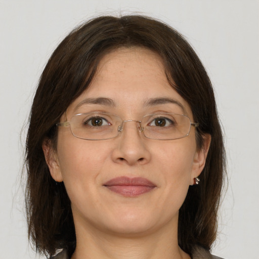 Joyful white adult female with medium  brown hair and brown eyes