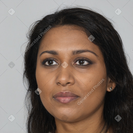 Joyful black young-adult female with long  black hair and brown eyes