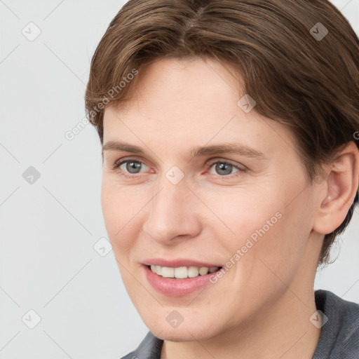 Joyful white young-adult female with short  brown hair and grey eyes