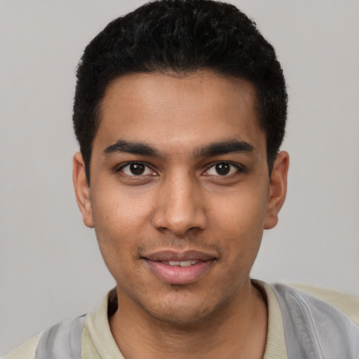 Joyful latino young-adult male with short  black hair and brown eyes