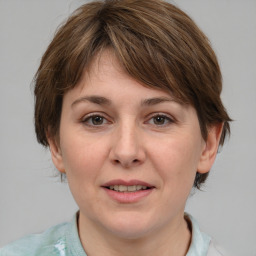 Joyful white adult female with medium  brown hair and grey eyes