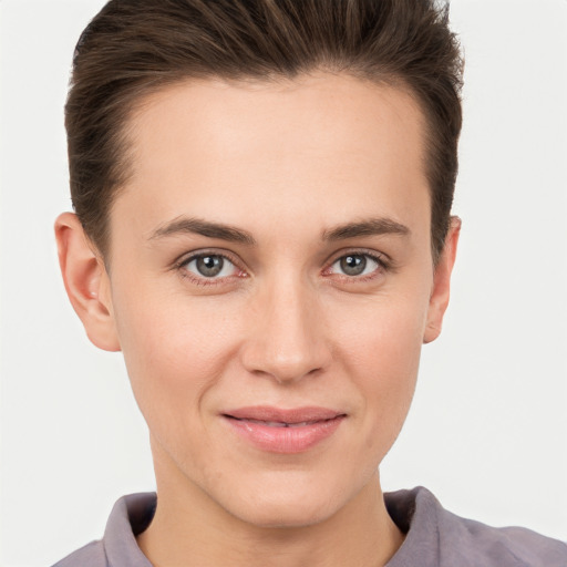 Joyful white young-adult female with short  brown hair and brown eyes