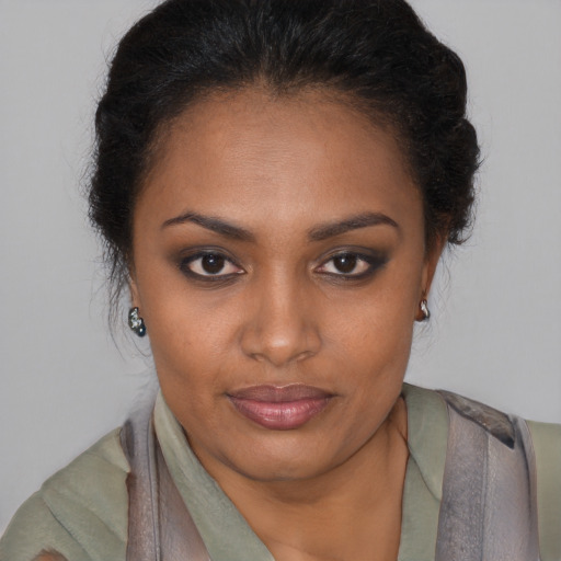 Joyful black young-adult female with short  brown hair and brown eyes