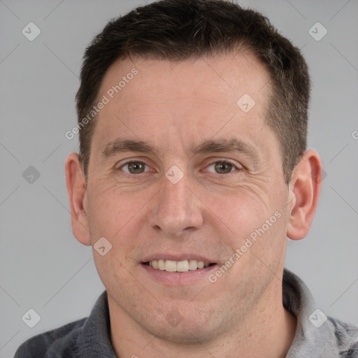 Joyful white adult male with short  brown hair and grey eyes