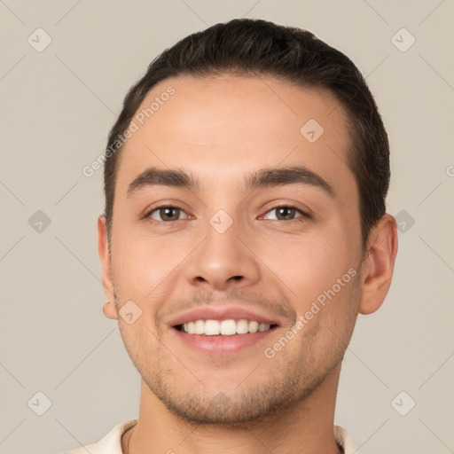 Joyful white young-adult male with short  brown hair and brown eyes