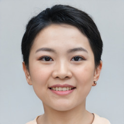 Joyful asian young-adult female with short  black hair and brown eyes