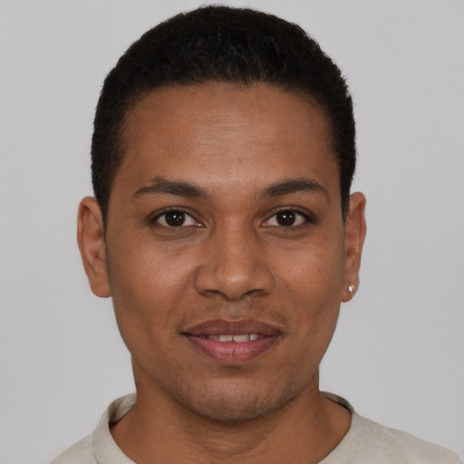 Joyful latino young-adult male with short  black hair and brown eyes