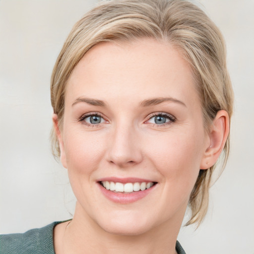 Joyful white young-adult female with medium  brown hair and blue eyes