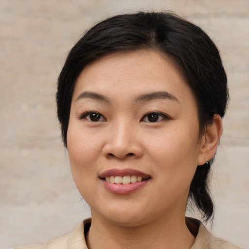 Joyful asian young-adult female with medium  brown hair and brown eyes