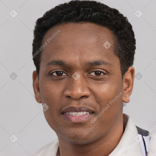 Joyful black young-adult male with short  black hair and brown eyes