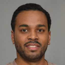 Joyful latino young-adult male with short  brown hair and brown eyes