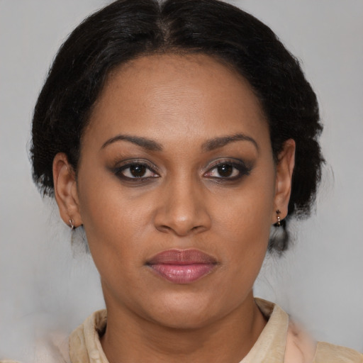 Joyful latino adult female with medium  brown hair and brown eyes