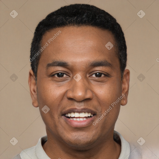 Joyful black young-adult male with short  black hair and brown eyes