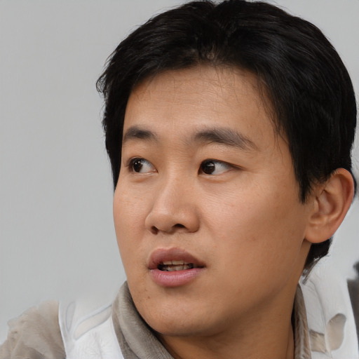 Neutral asian young-adult male with short  black hair and brown eyes