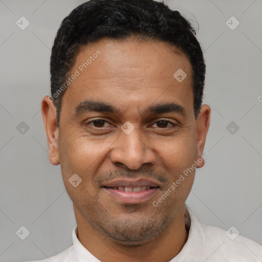 Joyful latino adult male with short  black hair and brown eyes