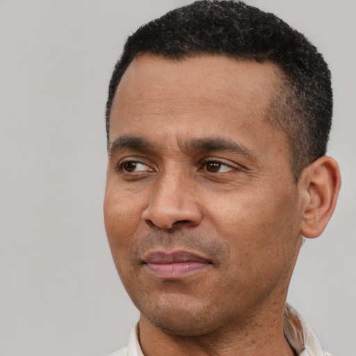 Joyful latino adult male with short  black hair and brown eyes