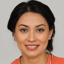 Joyful white young-adult female with medium  brown hair and brown eyes