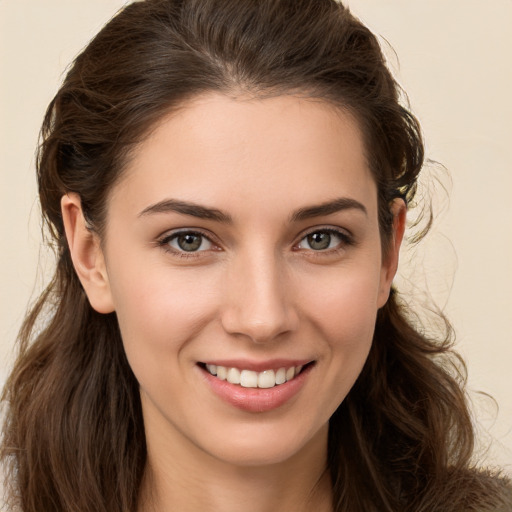 Joyful white young-adult female with long  brown hair and brown eyes