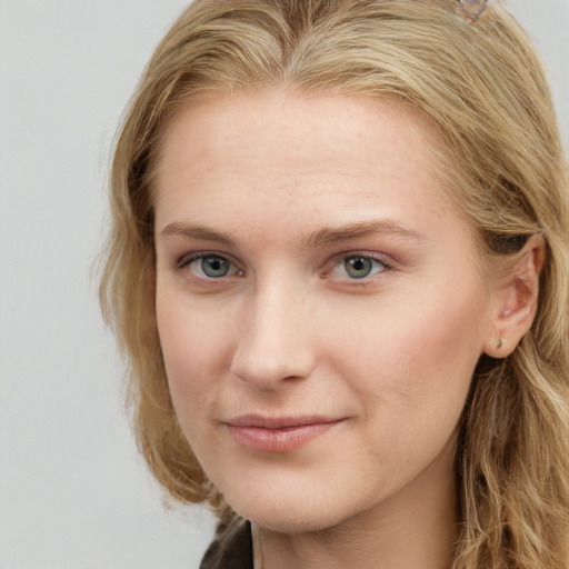 Joyful white young-adult female with long  brown hair and blue eyes