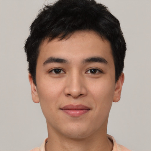 Joyful asian young-adult male with short  brown hair and brown eyes