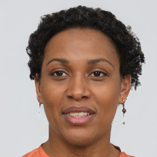 Joyful black adult female with short  brown hair and brown eyes