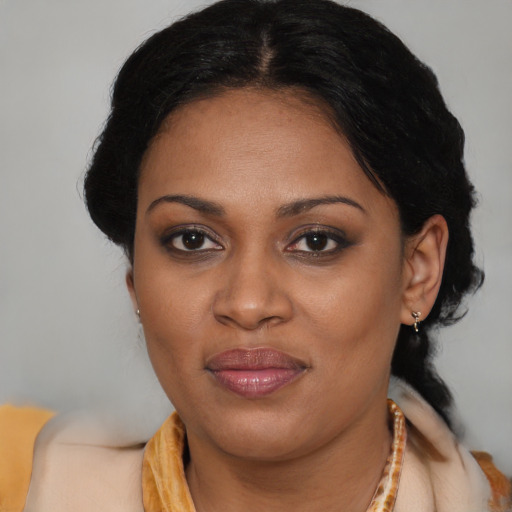 Joyful black adult female with medium  black hair and brown eyes